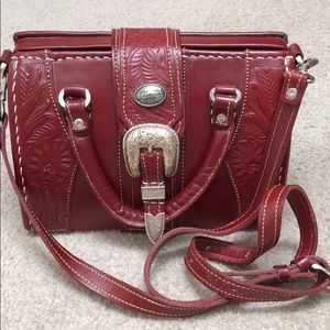 Red leather purse with western buckle.